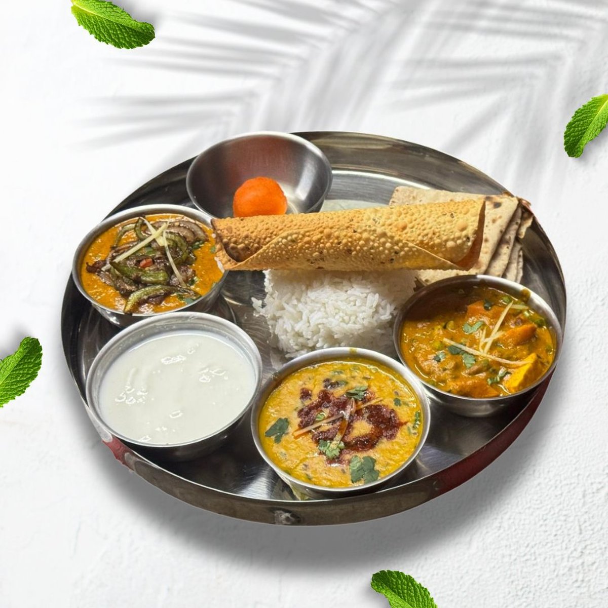 Vegetarian thali with multiple bowls on a plate